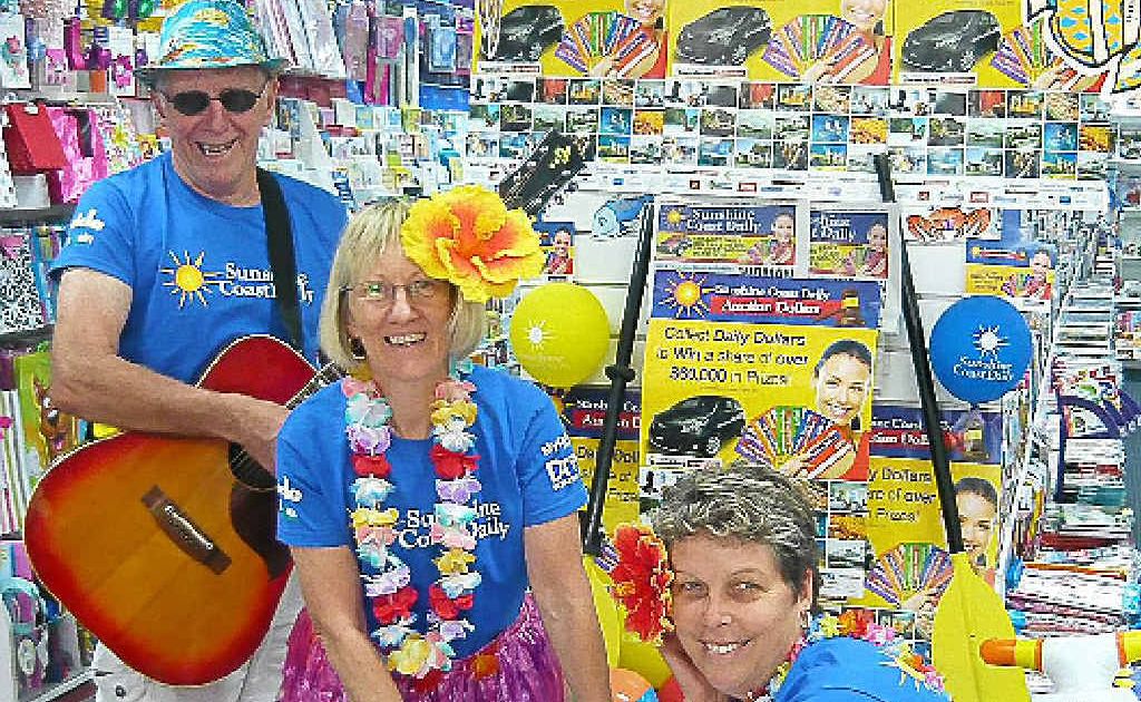 Local musician Kevin Brand gets into the spirit of the Daily Dollars promotion with Marlene Clews and Nicky Smith. Local musician Kevin Brand gets into the spirit of the Daily Dollars promotion with Marlene Clews and Nicky Smith.